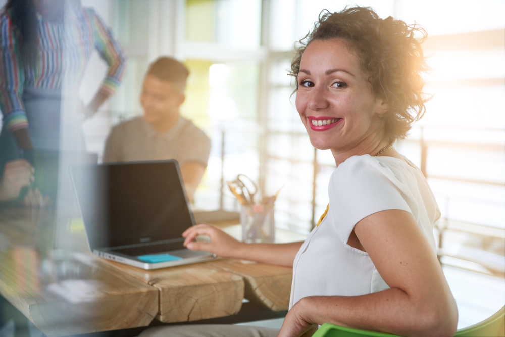 Image of a succesful casual business woman using laptop during meeting-2 Image of a succesful casual business woman using laptop during meeting-2